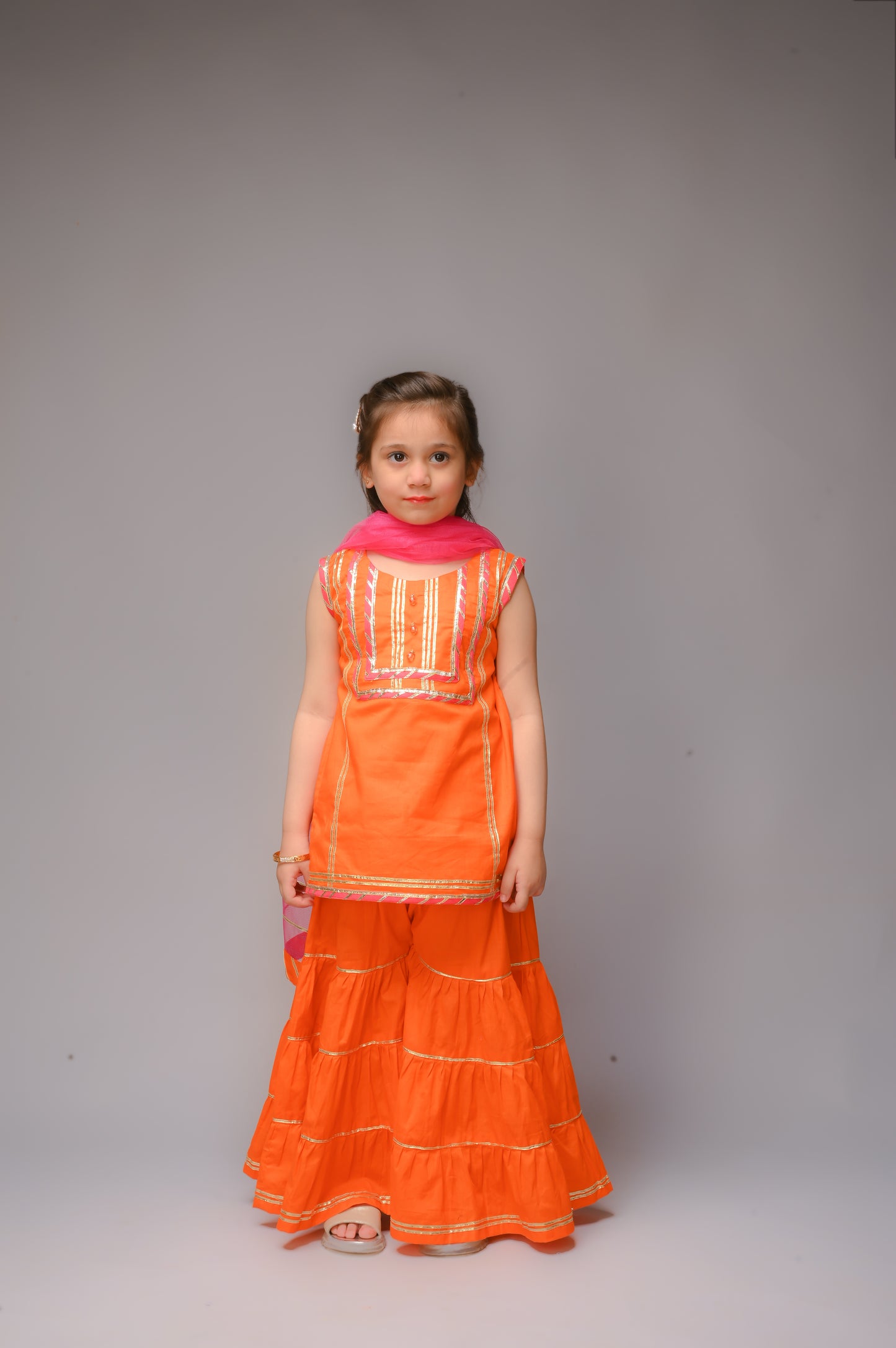 3 piece Orange Cotton Sleeveless Gharara Suit with Shocking Pink net Dupatta & Shocking Pink & Golden Laces.(Stitch).