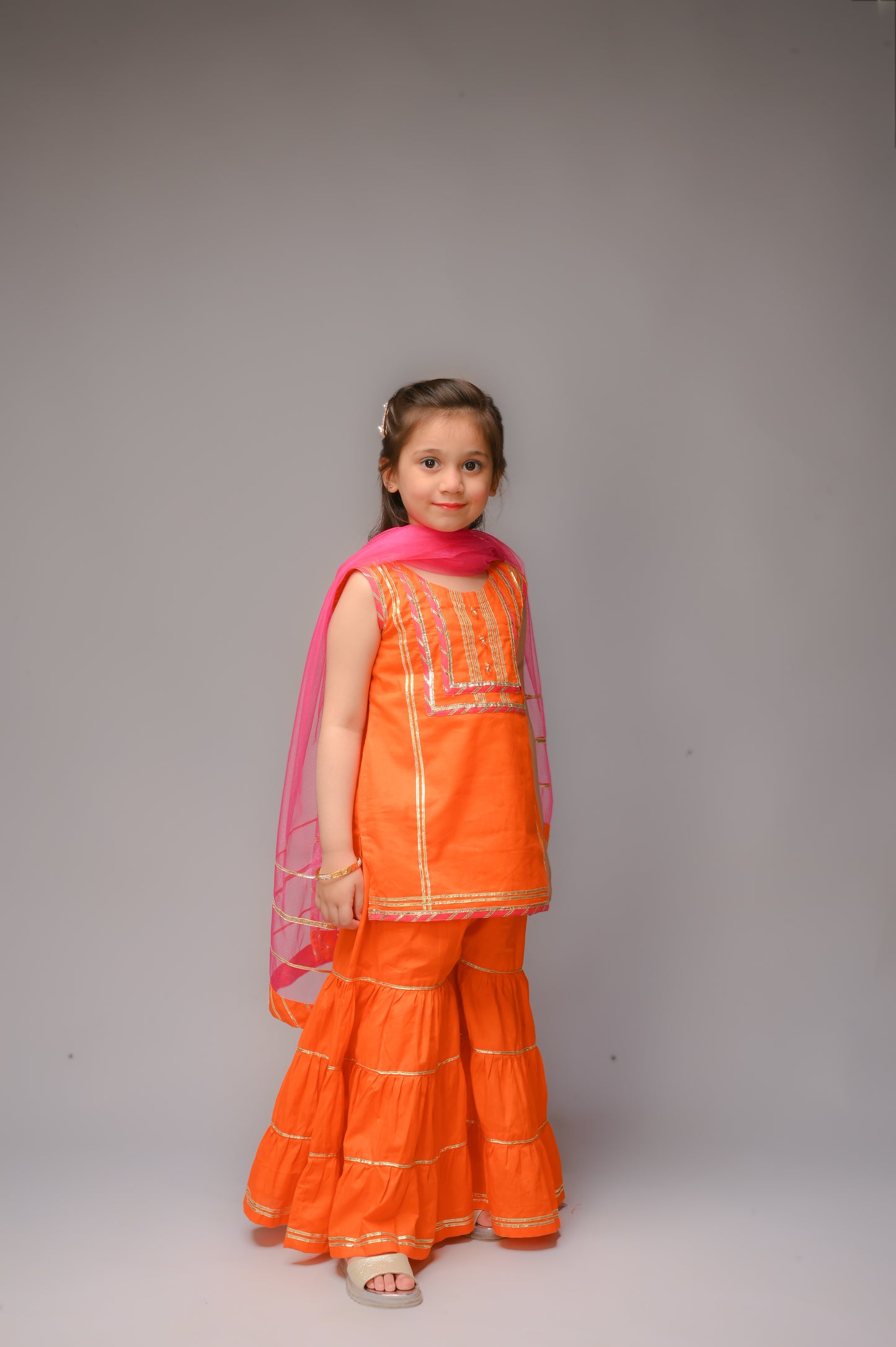 3 piece Orange Cotton Sleeveless Gharara Suit with Shocking Pink net Dupatta & Shocking Pink & Golden Laces.(Stitch).