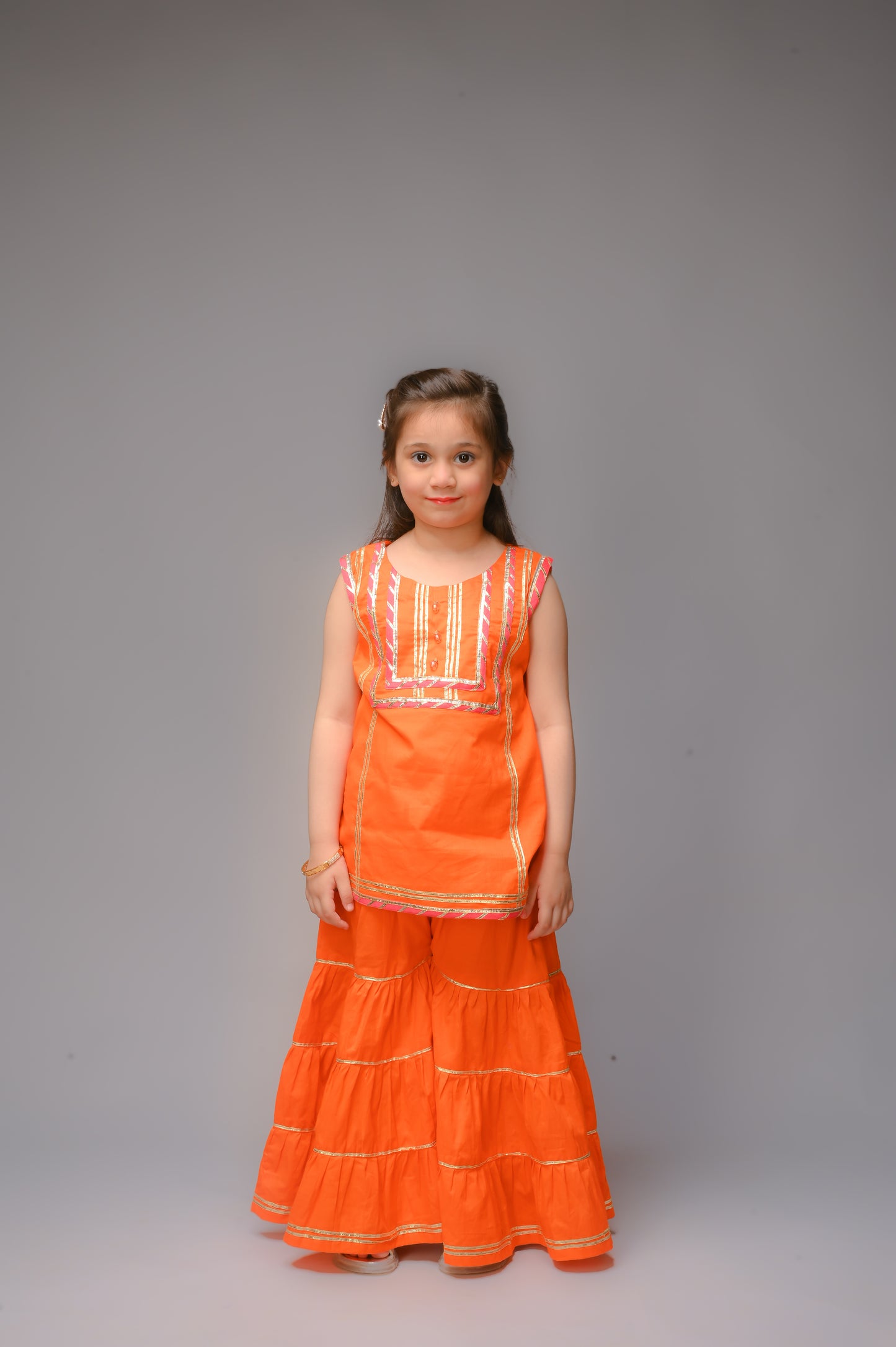 3 piece Orange Cotton Sleeveless Gharara Suit with Shocking Pink net Dupatta & Shocking Pink & Golden Laces.(Stitch).