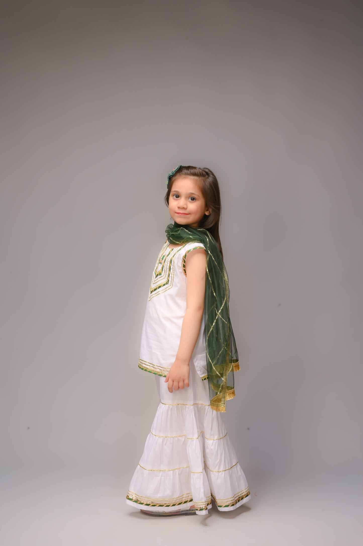 3 piece White Cotton Sleeveless Gharara Suit with Bottle Green net Dupatta & Bottle Green & Golden Laces.(Stitch).